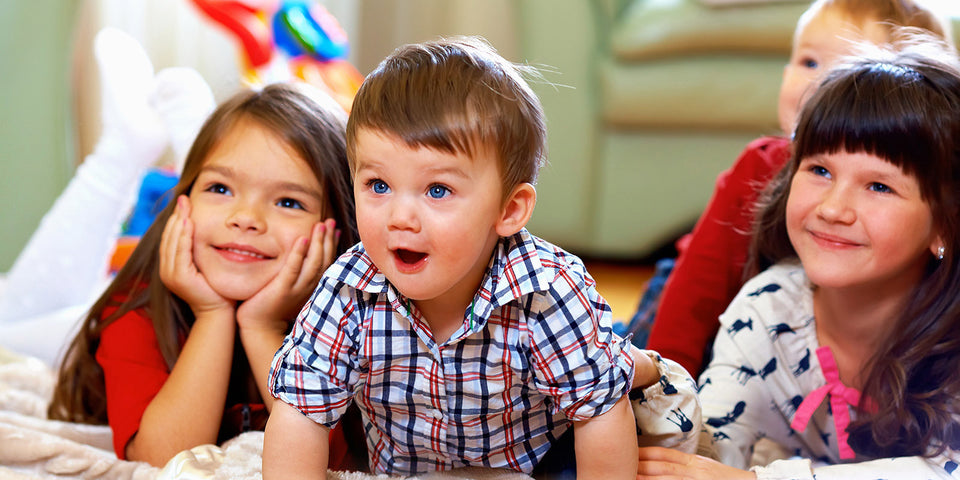 The kindergarten kids enjoying a TV show